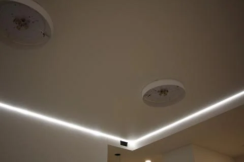 Stretch ceiling with led strip lighting and round vent Stock Photos