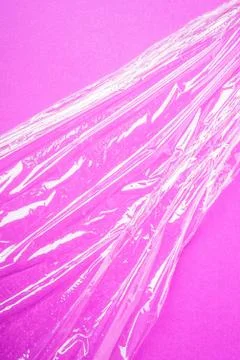 Stretch wrap plastic on pink background, minimalistic creative layout Stock Photos