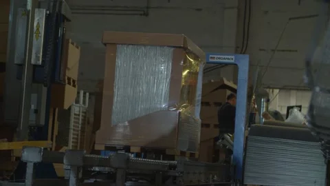 Stretch Wrapping Machine spinning around the box Stock-Footage 153470197