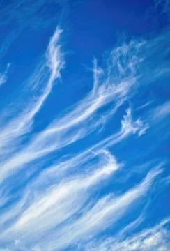 Stretched clouds in the blue sky Stock Photos