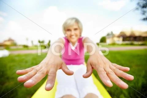 Stretched image of a woman doing exercises with focus on her hands Stock Photos