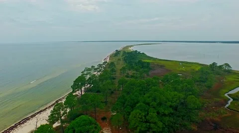 Stretched ocean lagoon flyover on a calm, cloudy day Stock Footage 54940770