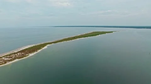 Stretched ocean lagoon flyover on a calm, cloudy day Stock Footage 54942279