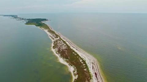Stretched ocean lagoon flyover on a calm, cloudy day Stock Footage 54943236