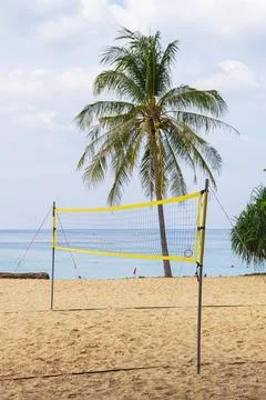 Stretched volleyball net for playing on the sandy beach. Stock Photos