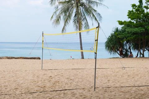 Stretched volleyball net for playing on the sandy beach. Stock Photos