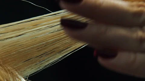 Stretching and combing shiny lock of hair Stock-Footage 60253916
