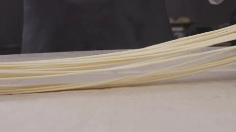 Stretching dough for hand-pulled noodles. Stock Footage 313981665