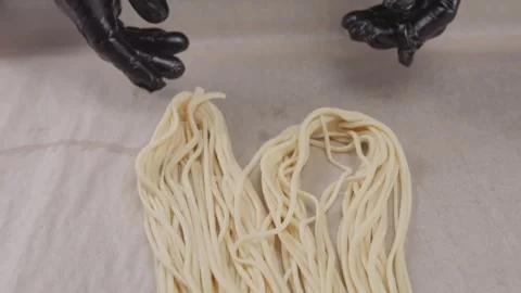 Stretching dough for hand-pulled noodles. Stock Footage 314242000