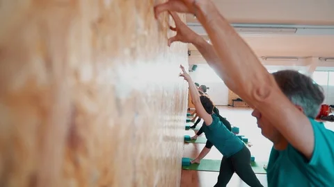 Stretching exercises leaning on a gym wall. Stock Footage 94839670