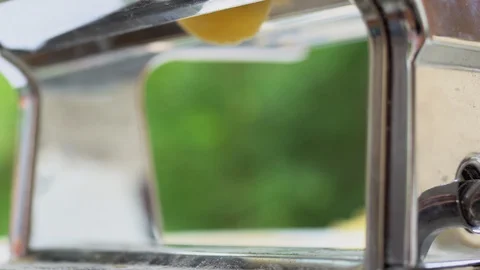 Stretching home made dough on a rolling machine. Preparation of thin dough for n Stock Footage 125962435