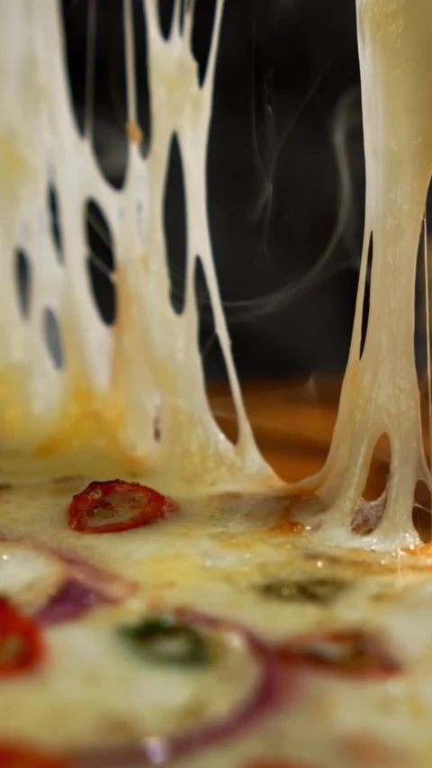 Stretching hot melted cheese from delicious pizza slice with red onion and .. Stock Footage 337443553