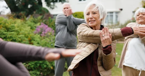 Stretching, instructor and senior people outdoor for wellness, exercise and warm Stock Footage 341102797