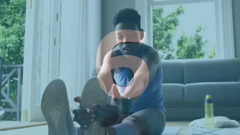 Stretching on mat, person exercising with countdown animation over living room Stock Footage 306273620
