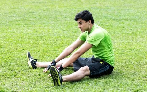 Stretching over grass Stock Photos