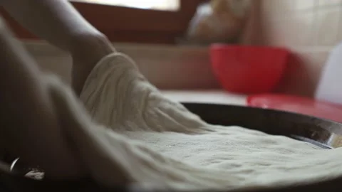 Stretching the pizza dough on the baking tray Stock Footage 155996029