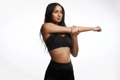 Stretching properly can decrease muscle soreness. Studio shot of a sporty young Stock Photos