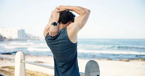 Stretching, runner and back of man by ocean to start workout, exercise and .. Stock Photos