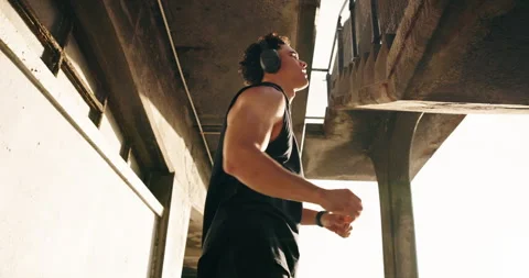 Stretching, runner and headphones with man at beach for workout start, health Stock Footage 332390380