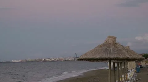 Strew umbrelas in cloudy day in Greece Stock Footage 8990130