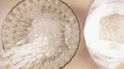 Strew white long grain rice in a bowl Stock Footage 92088331