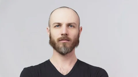 Strict bearded man looking at a camera over white background. Stock Footage 127034588