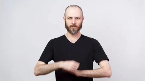 Strict bearded man looking at a camera over white background. Video stock 127034631