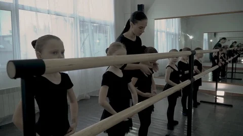 The strict female teacher of dance class teaches some movenments young student Video stock 113529650