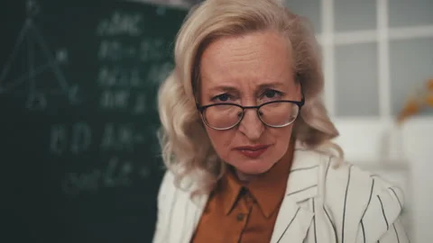 Strict geometry teacher attentively looking at camera, displeased with behavior Stock Footage 251859538