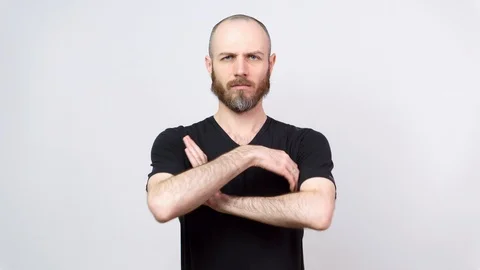 Strict man raising finger in warning gesture over white background. Serious Stock Footage 126701434