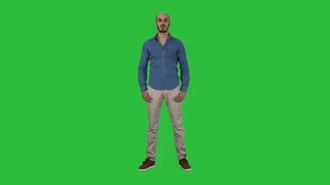 Strict man standing and looking into camera on a Green Screen, Chroma Key. Stock Footage 108242183