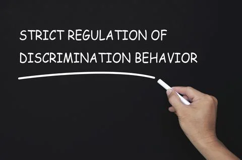 Strict regulation of discrimination behavior text written on blackboard. Sa.. Stock Photos