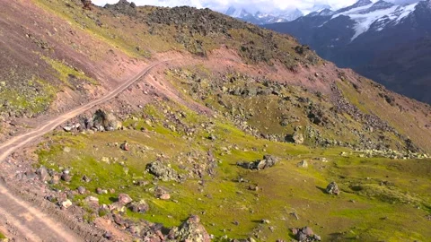 Stright flight over winding dirt road in a monutains Stock Footage 213373738
