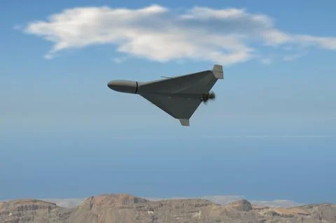 Strike drone in sky over desert mountains of Iran 스톡 사진