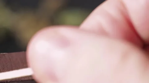 The strike of a match on the box and the ignition of the match. Video stock 169502066