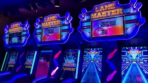 STRIKE! Young boy playing virtual bowling at the arcades and ball knocking Stock Footage 122859573