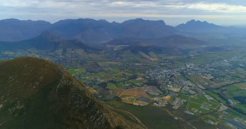 A striking aerial over a patchwork of fields and villages across a lush valley Video stock 128645962