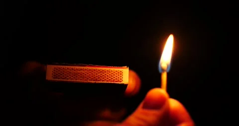 Striking and lighting flame on match isolated on black at night close-up Stock Footage 206283135