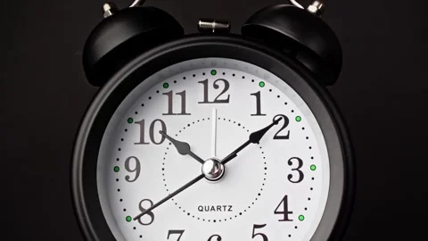 Striking black clock elegantly ticks in dark setting, marking time. Time moving Vidéo 327795376