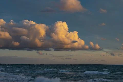 Striking clouds in evening mood over the sea Stock Photos