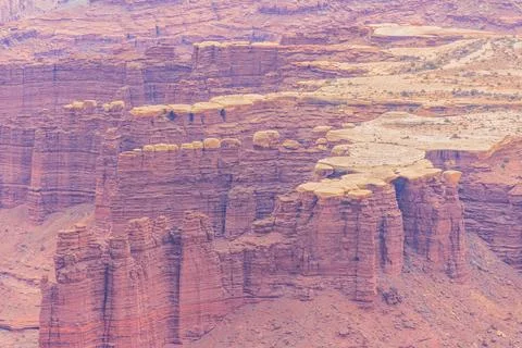 Striking eroded sandstone formations define a canyon landscape. 写真素材