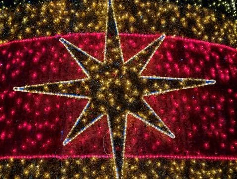 Striking giant star pattern radiating brilliance across vivid crimson backg.. Stock Photos