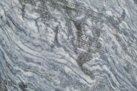 The striking gray marble features unique swirling patterns and subtle earth.. Stock Photos