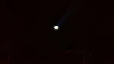 A striking illuminated object piercing through darkness Stock Footage 323121249