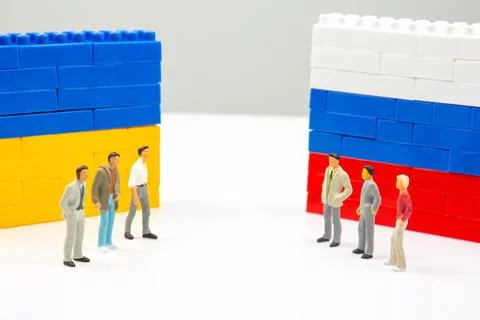 A striking image of tiny figures divided by blocks block walls in Ukrainian.. Stock Photos