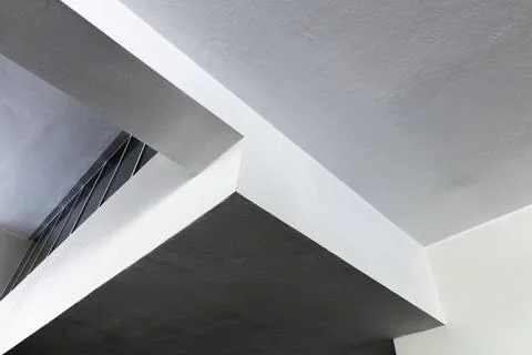 A striking interior scene featuring concrete girders and bold intersecting .. 스톡 사진