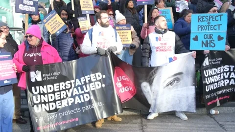 Striking nurses with placards, in protest of government cuts and unfair pay. Stock Footage 231612440