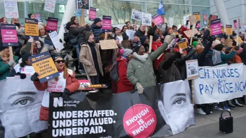 Striking nurses with placards, in protest of government cuts and unfair pay. Stock Footage 231612917