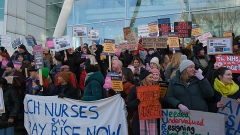 Striking nurses with placards, in protest of government cuts and unfair pay. Stock Footage 231613595