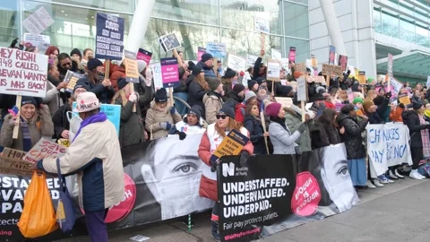 Striking nurses with placards, in protest of government cuts and unfair pay. Stock Footage 231614568